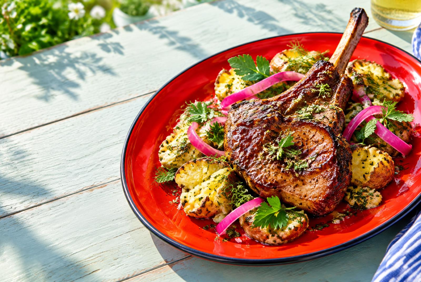 Ale-glazed Barnsley chop with smashed roast potato salad